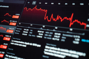 Stock market screen showing red declining graphs.