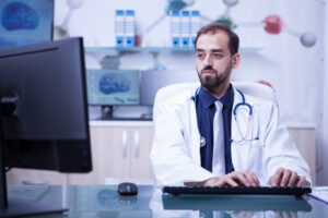Doctor reviewing patient data for medical coding.