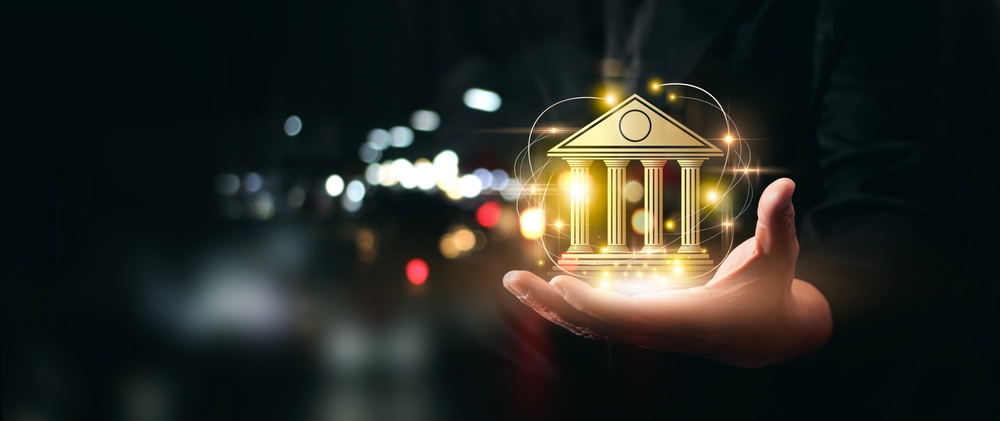 Businessman holding bank and technology